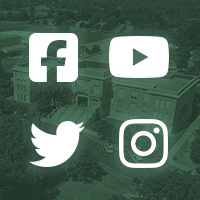 icons for facebook, twitter, instagram, and youtube in front of a dark green building