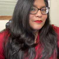 Dark haired woman in red shirt