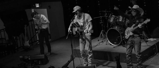 Black and white photo of a band playing onstage