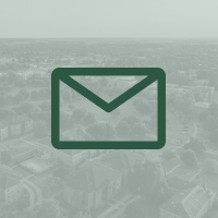 Illustration of an envelope overlaid on a light green image of campus from aerial view