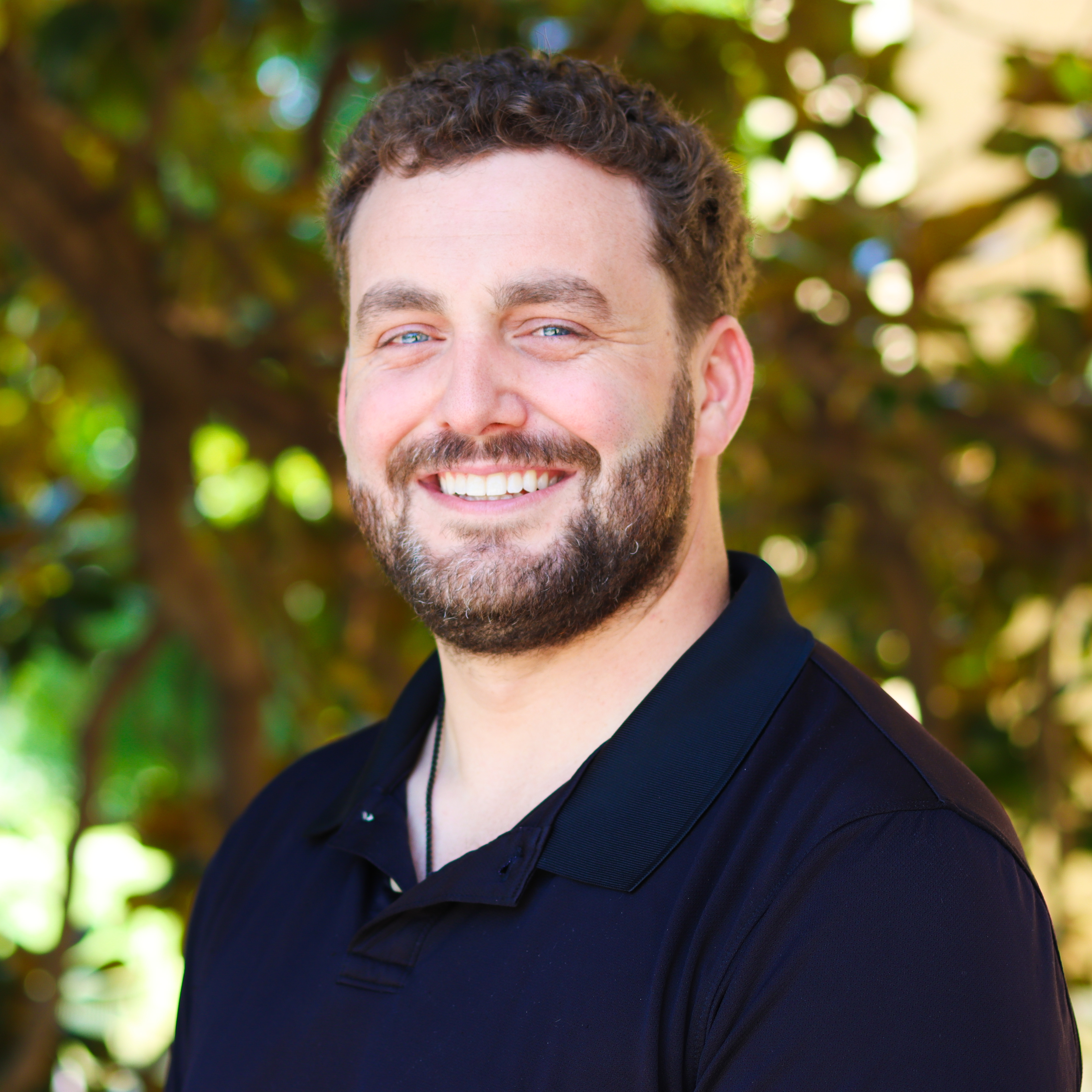 Smiling man in a navy blue shirt