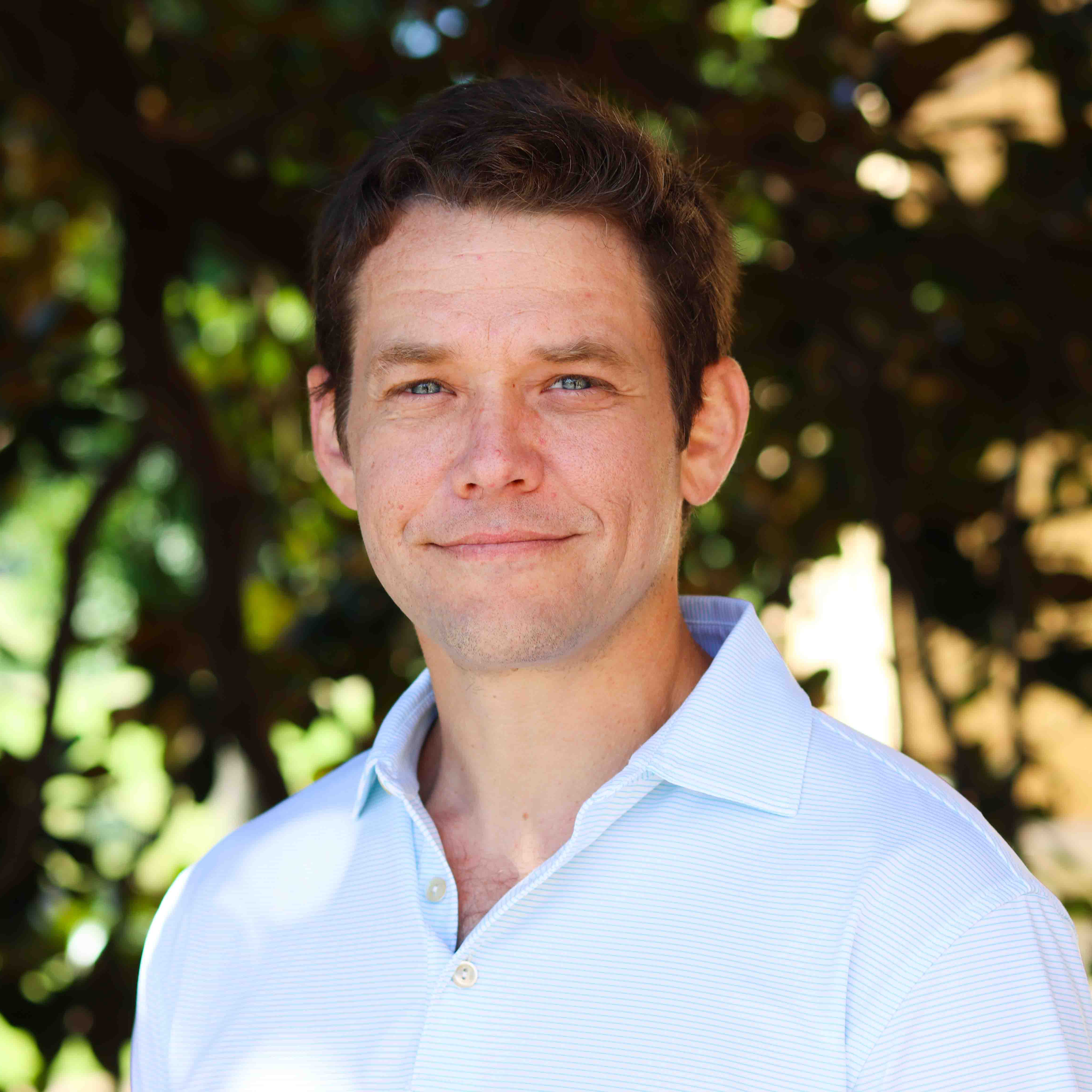 Man smiling in white shirt