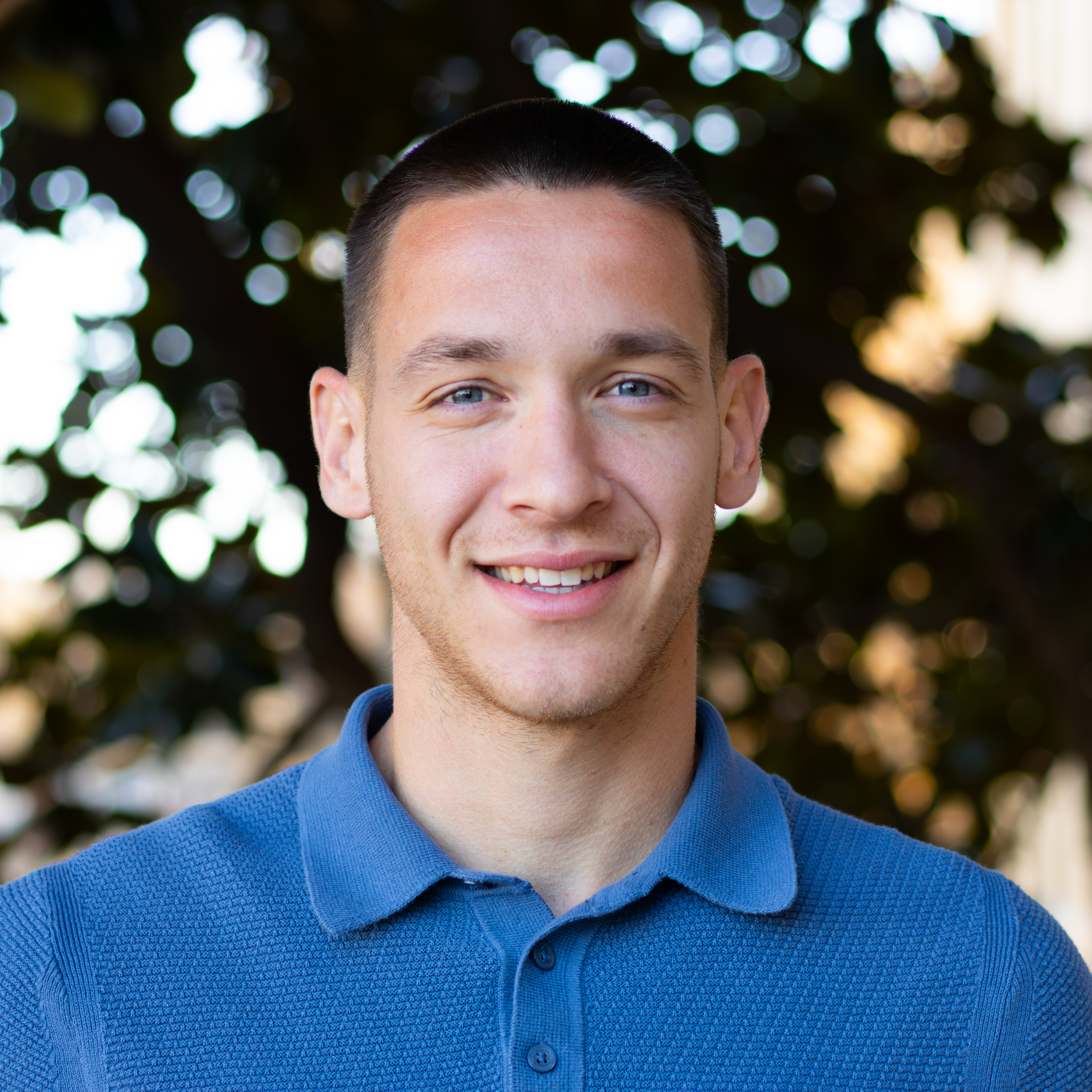 Man smiling in blue shirt
