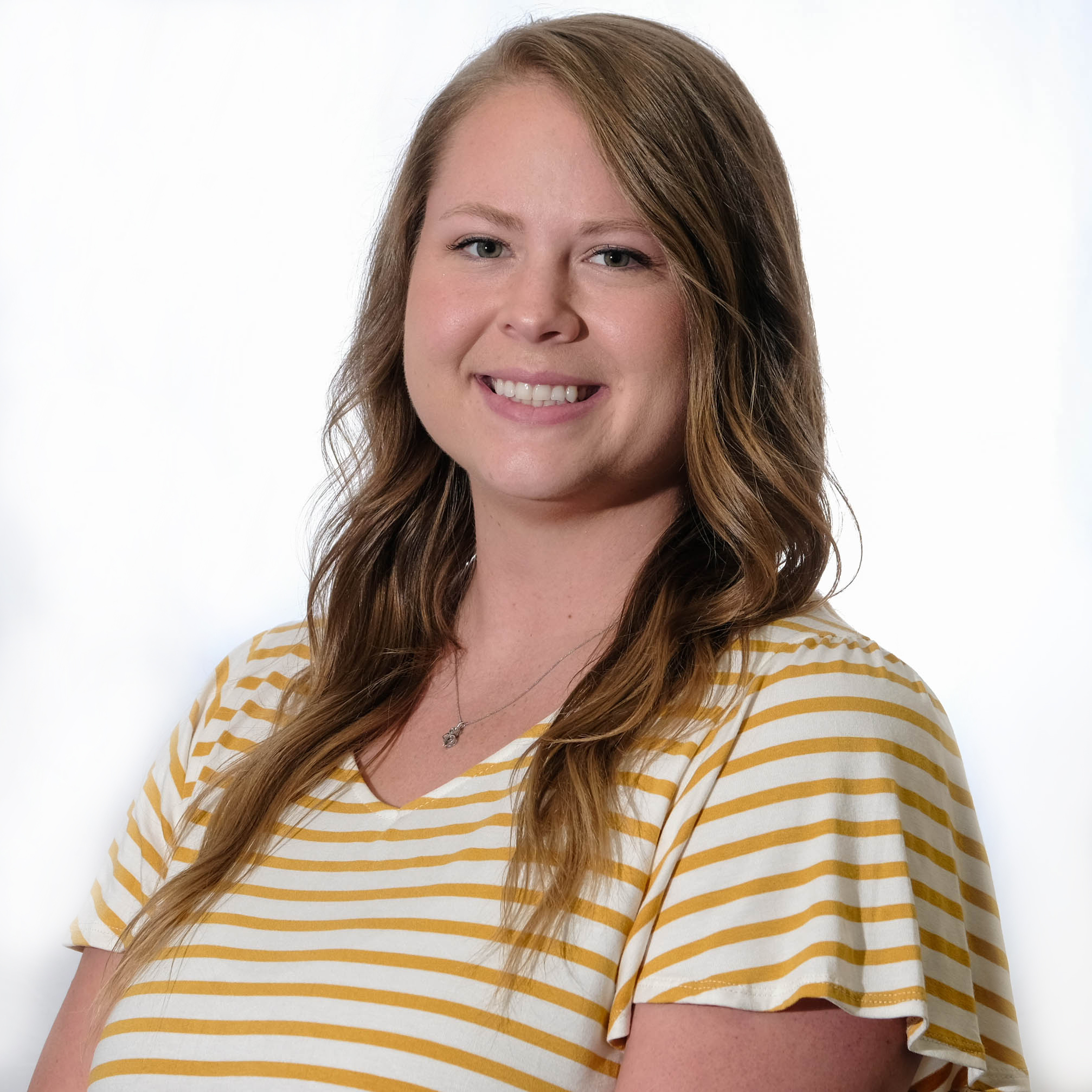 Smiling woman in white and yellow striped shirt