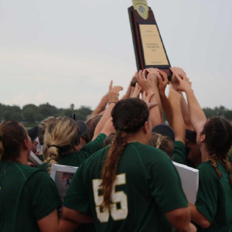 USAO Drover softball girls holding up national championship trophy
