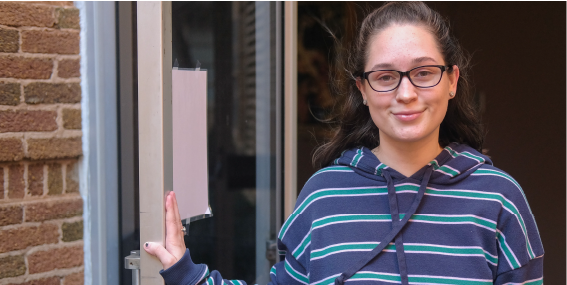 Cassidy Bowles holding door open