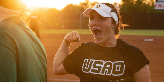 Madelyn Blair celebrating with a fist pump on the softball field. 